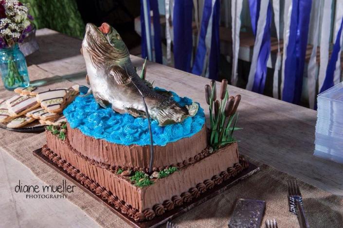 This realistic display of a fish leaping from blue water frosting is perfect for anyone who loved the outdoors!