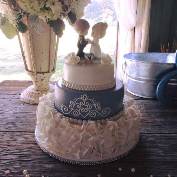 An adorable wedding cake with a Precious Moments topper.