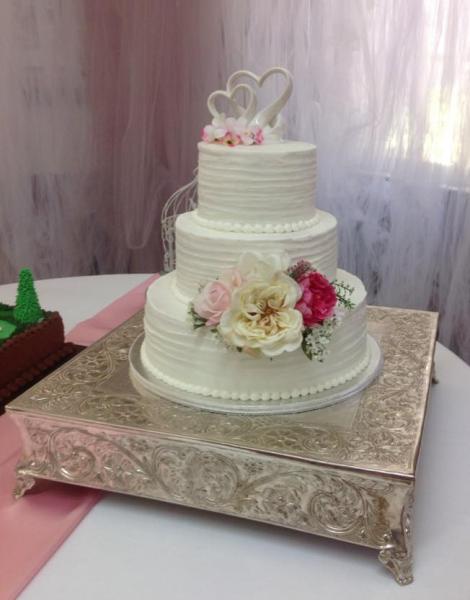 A beautiful 3 tier wedding cake with gorgeous flowers.