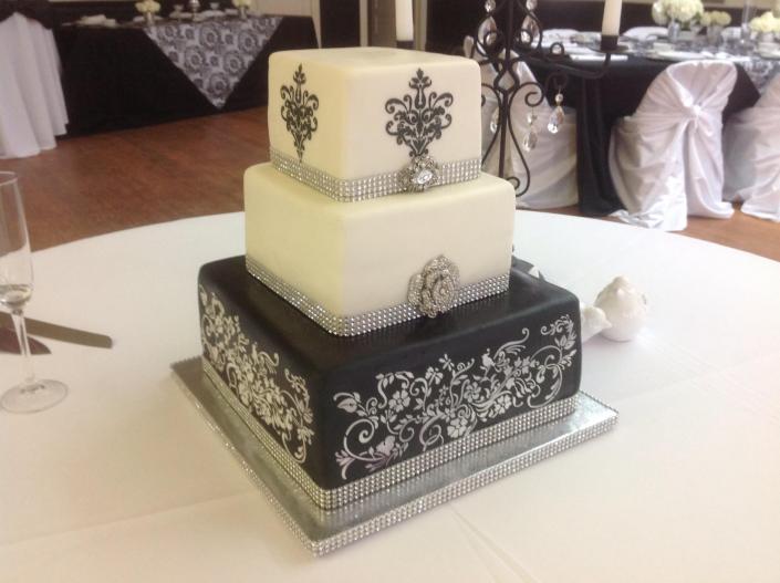 An elegant 3 tier black and white wedding cake.