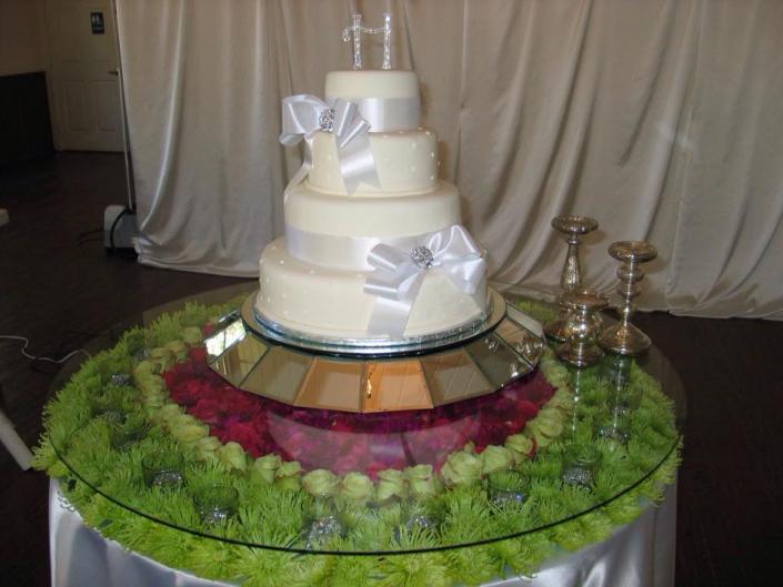 A beautiful wedding cake with white ribbon.