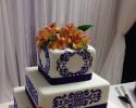 A beautiful blue and orange wedding cake.