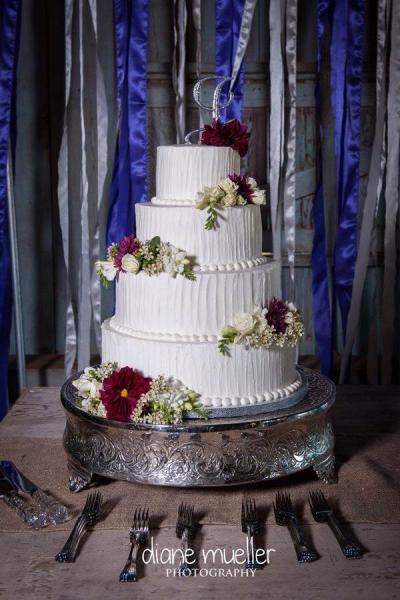 A stunning 4 tier wedding cake with fresh flowers.