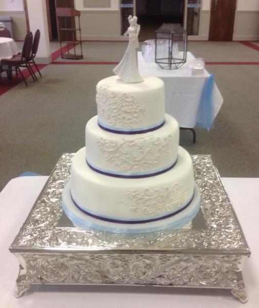 A 3 tier wedding cake with a subtle hint of blue.