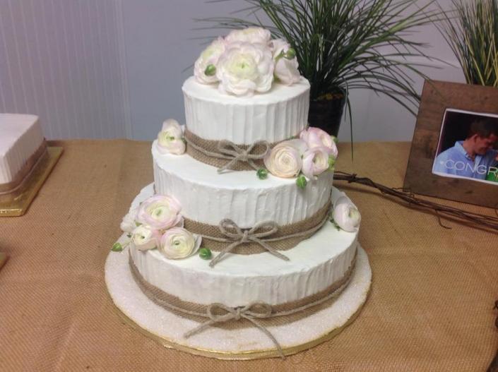 A beautiful wedding cake with burlap.