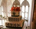 An elegant black and white wedding cake with lilies.