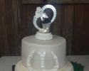 A unique wedding cake with a belt buckle and horseshoes.