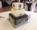 An elegant 3 tier black and white wedding cake.