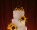 A beautiful 4 tier wedding cake with sunflowers.