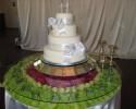 A beautiful wedding cake with white ribbon.