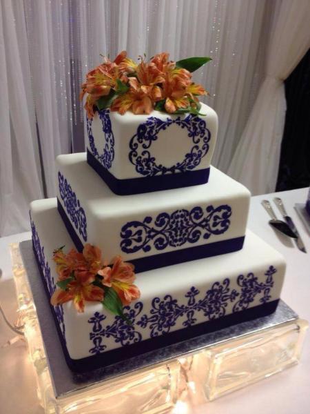 A beautiful blue and orange wedding cake.