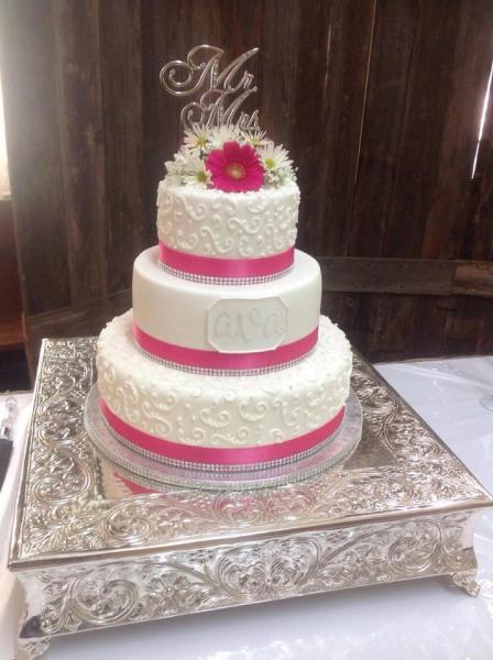 A beautiful pink & white wedding cake.