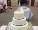 A 3 tier wedding cake with a subtle hint of blue.